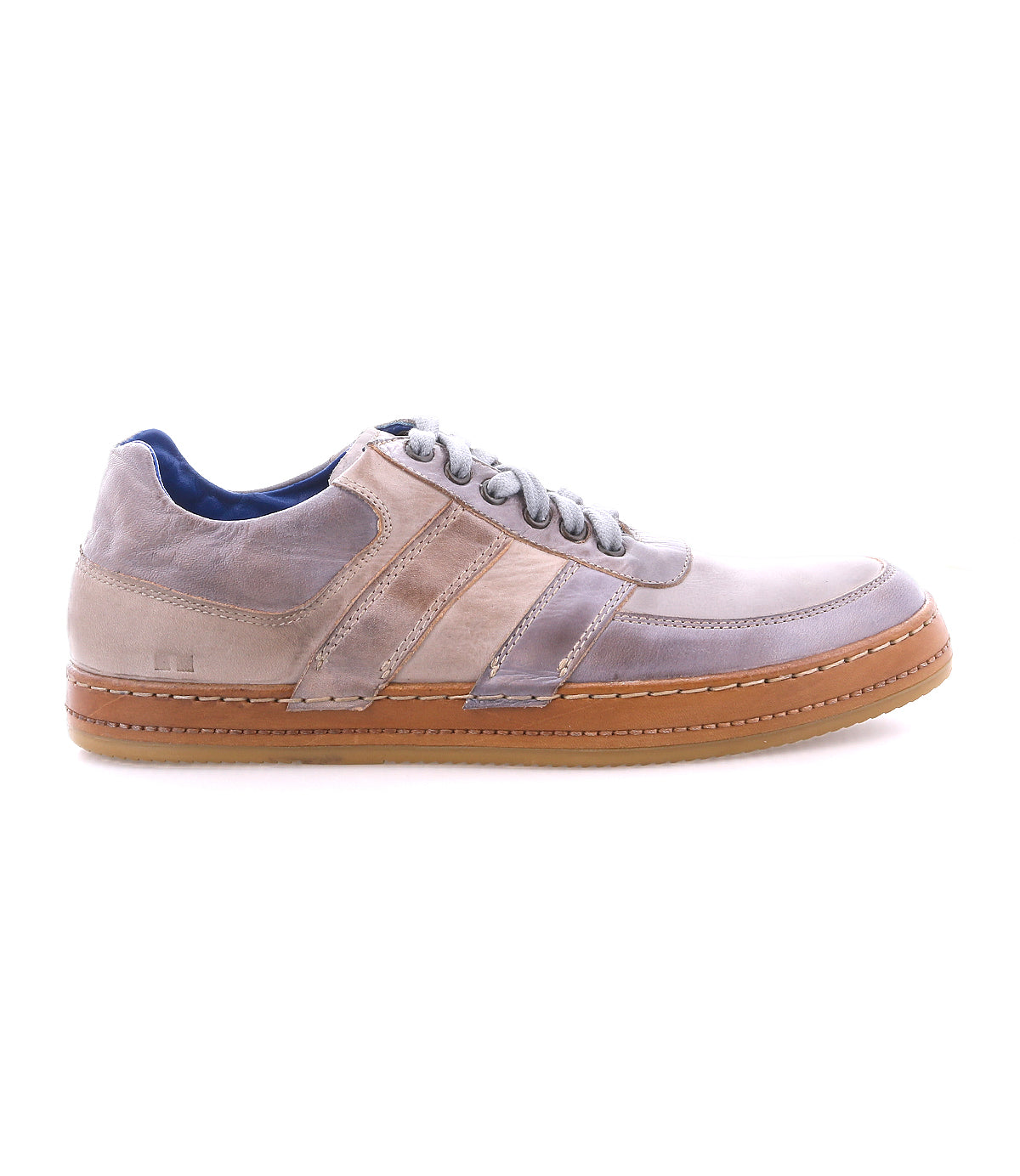 The Firepower sneaker by Bed|Stü is a taupe and gray low-top everyday shoe featuring a brown textured sole, suede and leather stripe accents, side stitching, and gray laces. Shown in profile view on a white background.