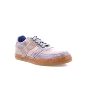 The Bed|Stü Firepower sneaker is displayed against a white background, featuring a single gray and beige design with a brown textured sole, gray laces, blue inner lining, and subtle leather stripe details.