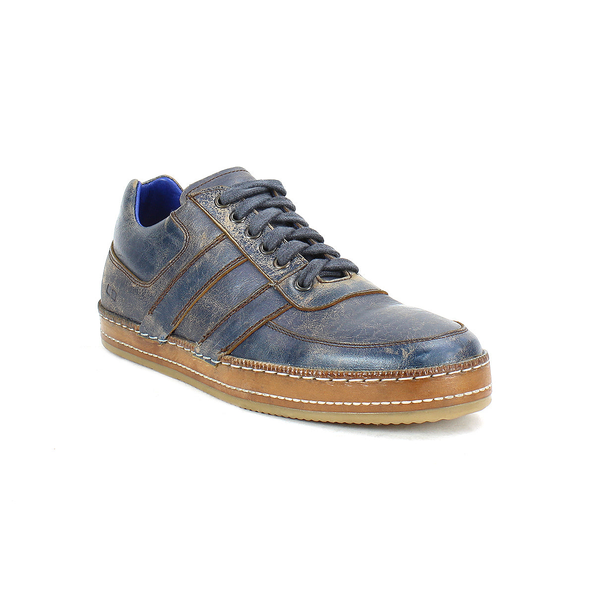 Introducing the Bed|Stü Firepower: a single dark blue leather everyday sneaker featuring brown accents, a tan textured sole, blue lining, stitch detailing, and laces, with sleek leather stripe details—shown against a white background.