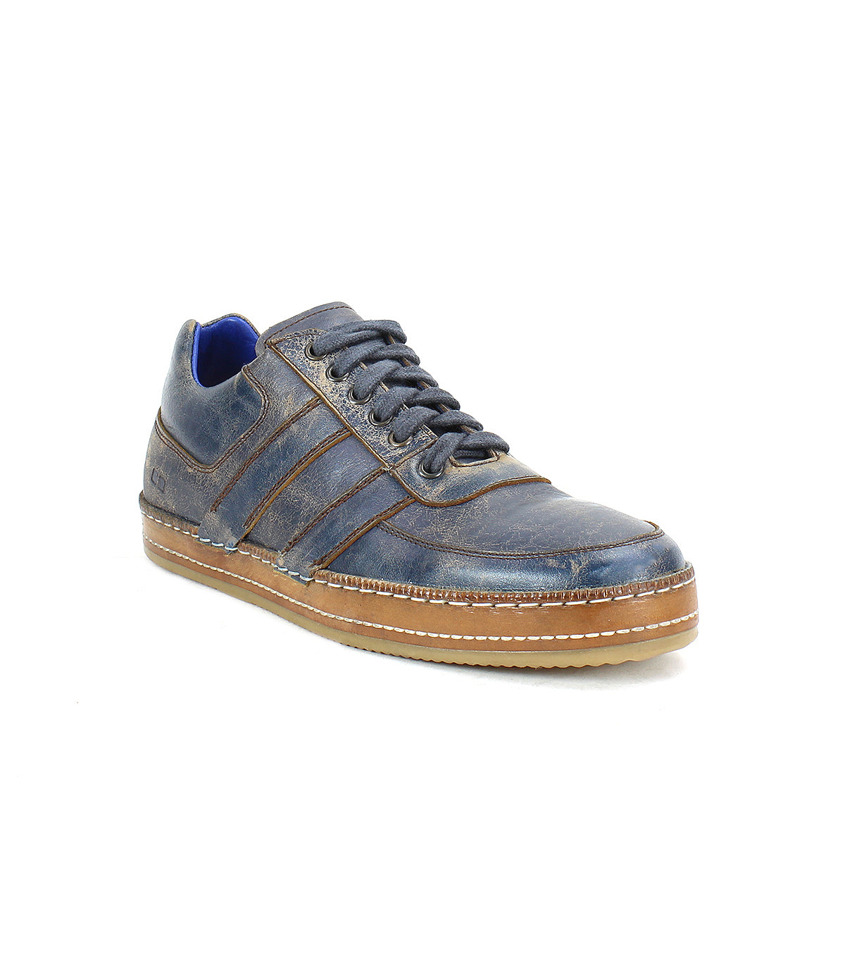 Introducing the Bed|Stü Firepower: a single dark blue leather everyday sneaker featuring brown accents, a tan textured sole, blue lining, stitch detailing, and laces, with sleek leather stripe details—shown against a white background.
