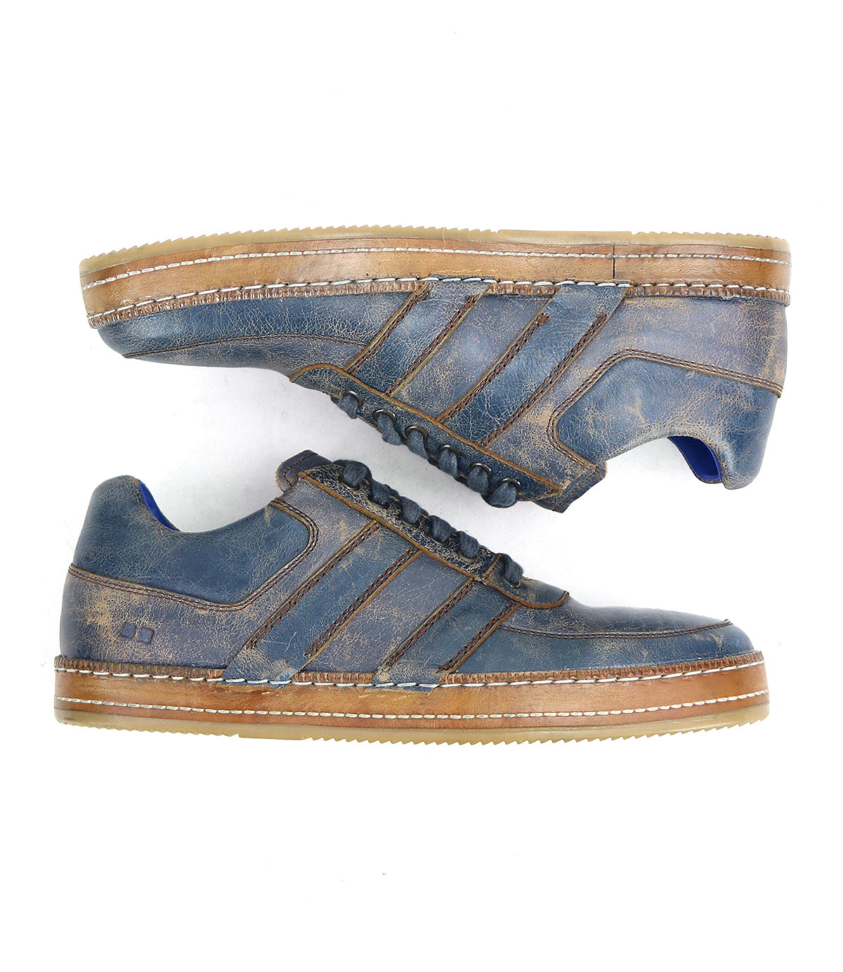 A side view of the Bed|Stü Firepower sneakers—a pair of distressed blue leather shoes featuring tan textured soles and three leather stripe accents on the side.