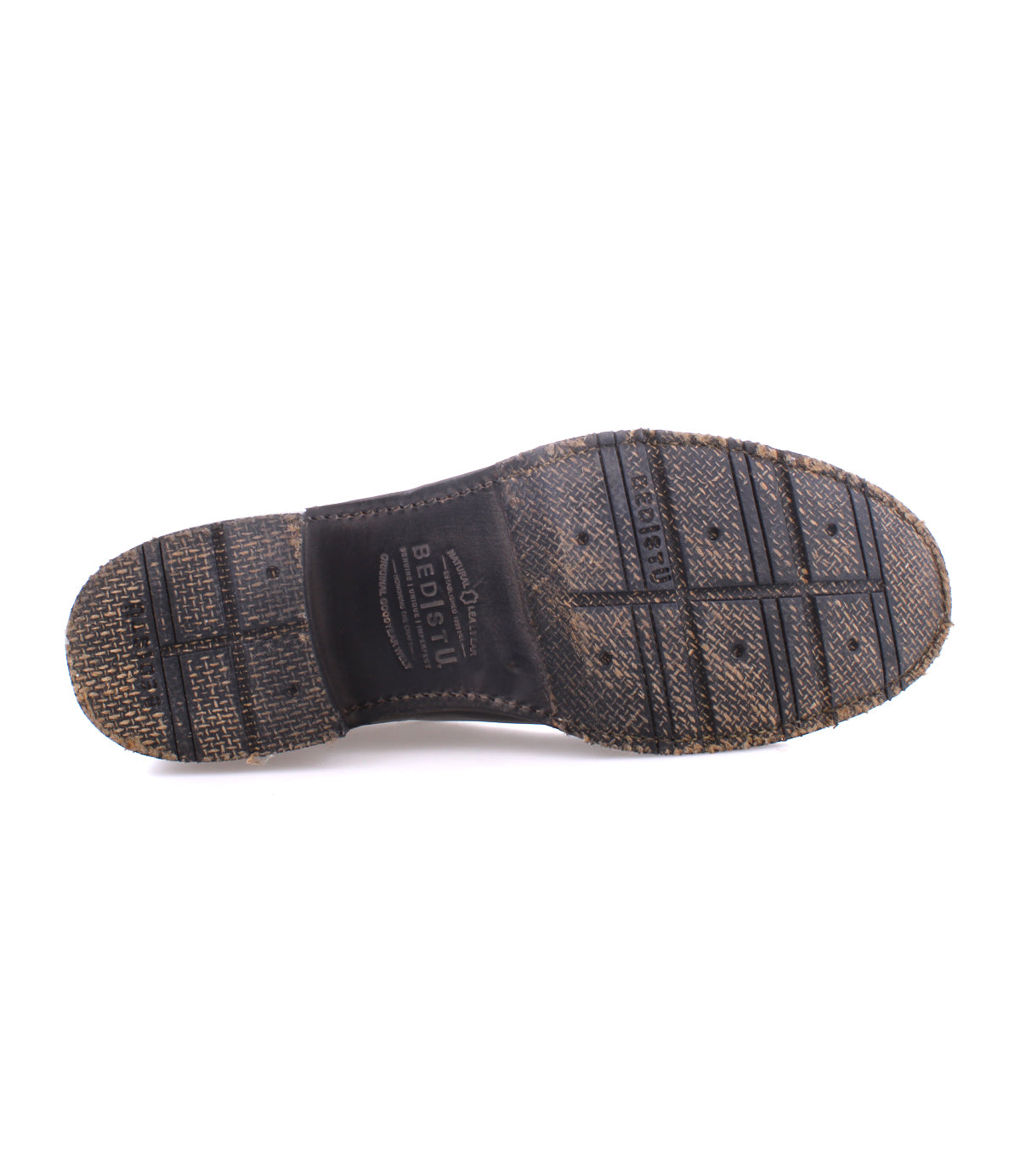 The underside of a worn, textured black shoe sole with visible tread patterns and the words “BESIO” and “GOODYEAR WELTED” embossed, highlighting the sturdy Goodyear welt construction featured in Bed|Stü's Fierce washed leather derby design.