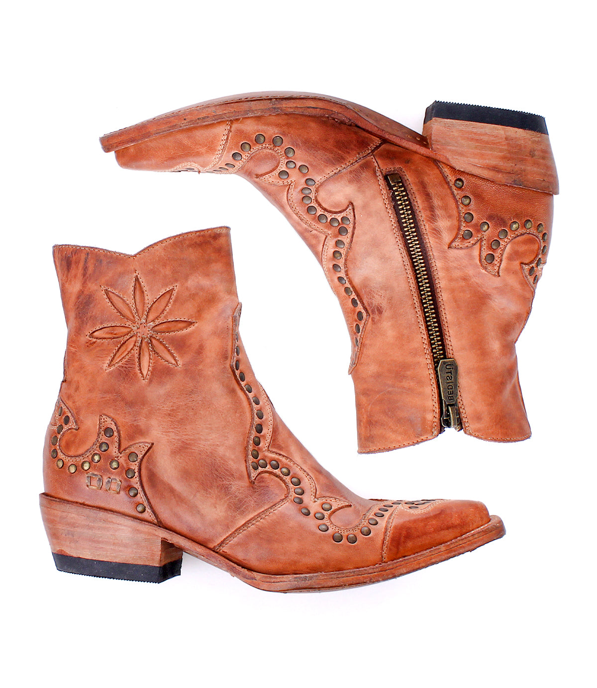 Frio brown leather Western bootie ankle boots by Bed|Stü, featuring decorative stitching, floral cutout details, antiqued brass studs, and side zippers, displayed against a white background.
