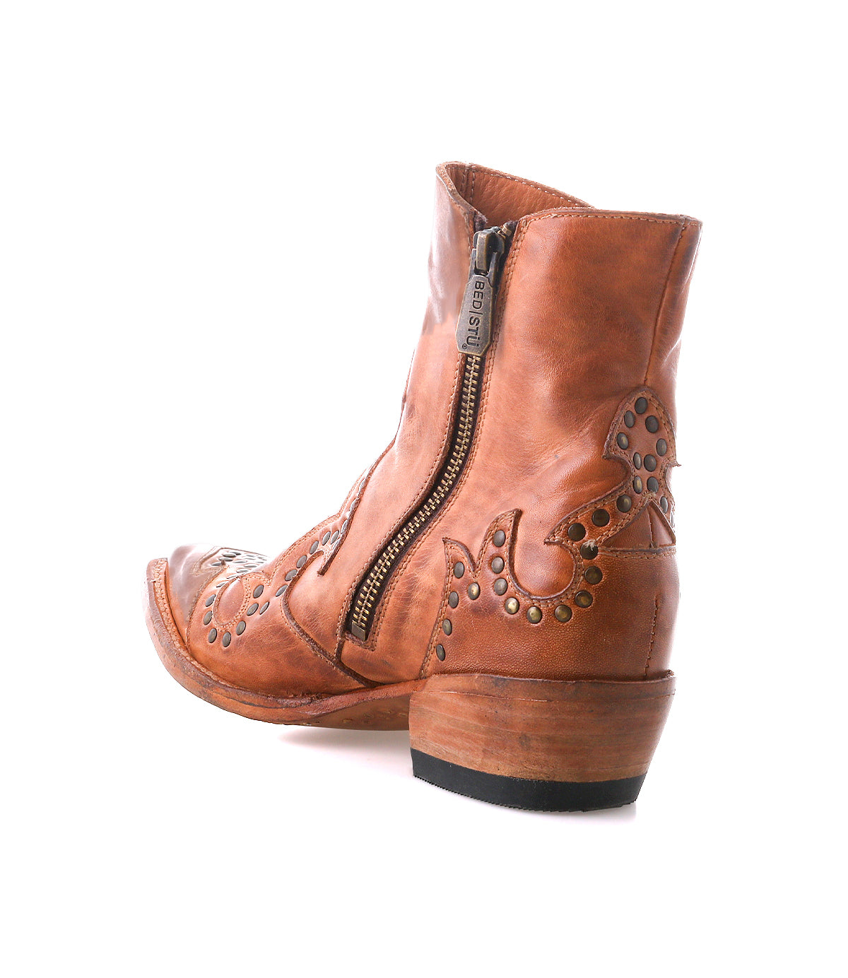 The Frio bootie by Bed|Stü features brown leather with decorative stitching, antiqued brass studs, a side zipper, and a low stacked heel, shown against a white background.