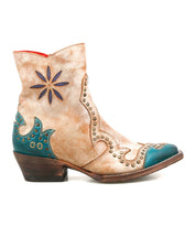 Frio Western bootie by Bed|Stü in tan and teal leather, featuring decorative stitching, antiqued brass stud accents, and a star-shaped cutout, shown from the side against a white background.