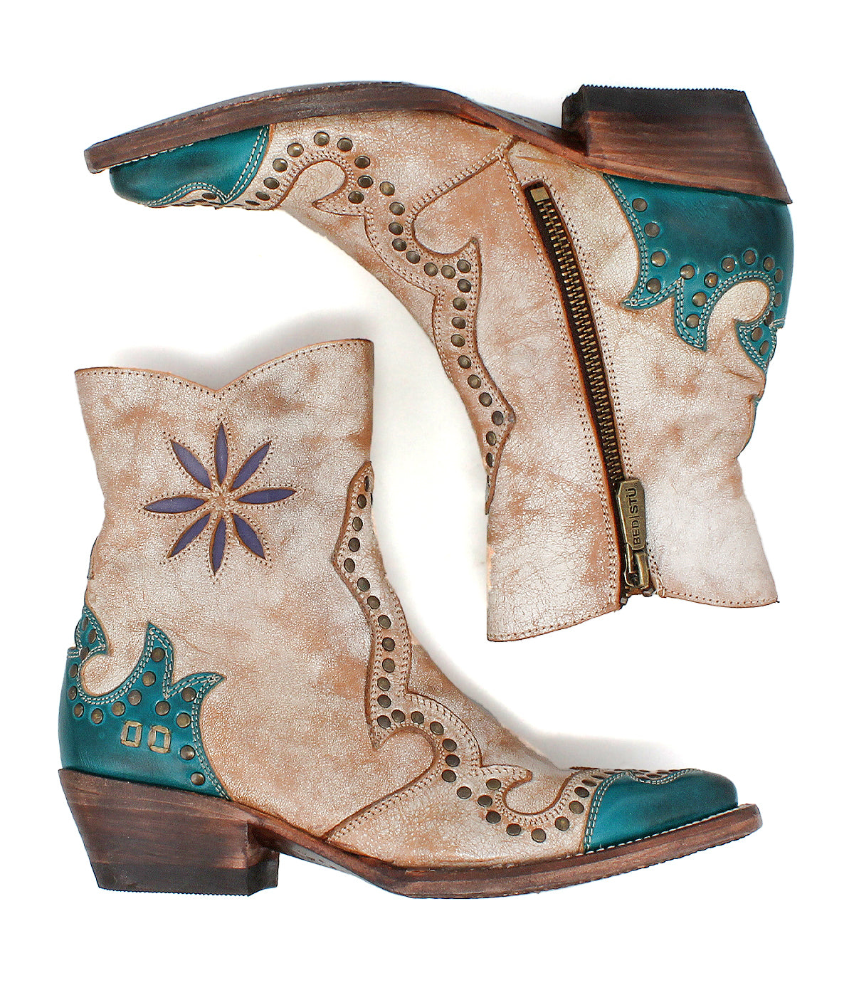 The Bed|Stü Frio booties in tan and turquoise feature decorative stitching, floral cutout accents, antiqued brass studs, and convenient side zippers, shown from both sides against a white background.