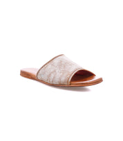 The Bed|Stü Gailee is a single tan and white leather slide sandal featuring an open toe, a textured upper, and a cushioned footbed for added comfort, shown on a white background.