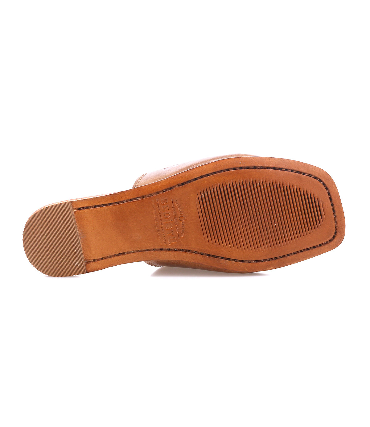 The bottom view of the Bed|Stü Gailee tan leather shoe showcases its rectangular toe, ribbed sole, and rubber heel grip, emphasizing its comfortable design and cushioned footbed.