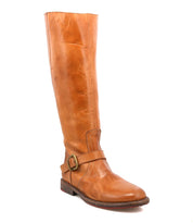 The Glaye by Bed|Stü is a single tall leather equestrian boot in tan, featuring a low heel and a vintage buckle at the side, standing upright against a white background.