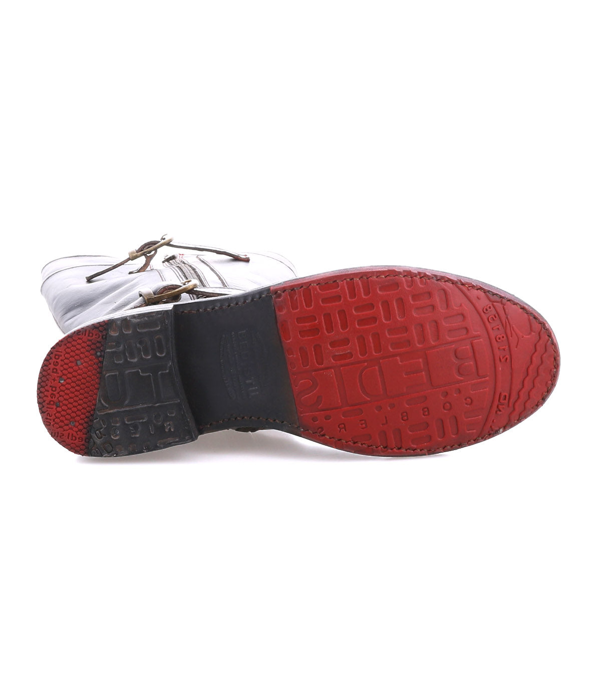 The image displays the bottom view of the Bed|Stü Gogo Lug shoe, featuring a white lace-up design with a textured red and black rubber lug outsole.