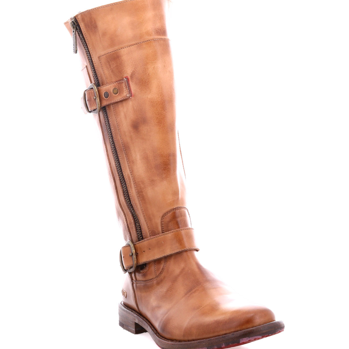 The Bed|Stü Gogo Lug is a tall brown mid-calf leather boot featuring a side zipper, two buckled straps, and a low heel on a sturdy lug outsole, shown against a white background.