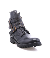 The Bed|Stü Grab is a black leather combat boot featuring three studded buckle straps, metal studs, and a thick Vibram sole, shown against a white background.