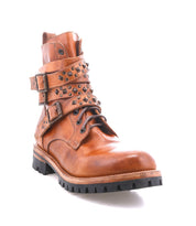 Bed|Stü "Grab" brown leather combat boot featuring a durable Vibram sole, decorative studded buckle straps, and side buckles, photographed on a white background.