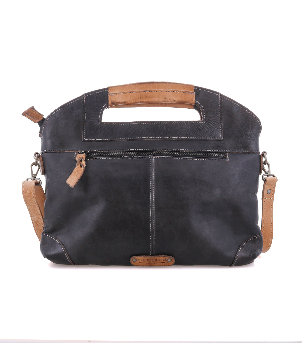 The Bed|Stü Greenway shoulder bag, displayed on a white background, is crafted from full-grain black leather with tan leather handles, an adjustable crossbody strap, a front zipper pocket, stitched detailing, and a secure zip-top closure.