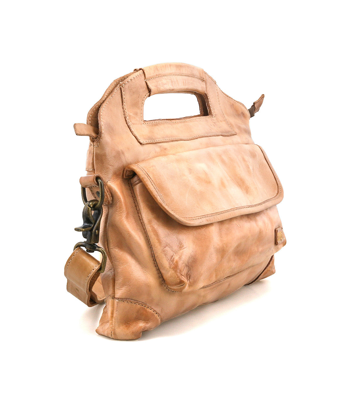 The Bed|Stü Greenway is a light brown full-grain leather handbag with a built-in handle, front flap pocket, and brass buckle accents, featuring a secure zip-top closure and displayed on a white background.