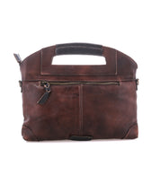 The Bed|Stü Greenway is a brown full-grain leather briefcase-style bag, featuring a built-in handle, front zipper pocket, minimal stitching details, and a secure zip-top closure—all photographed against a white background.