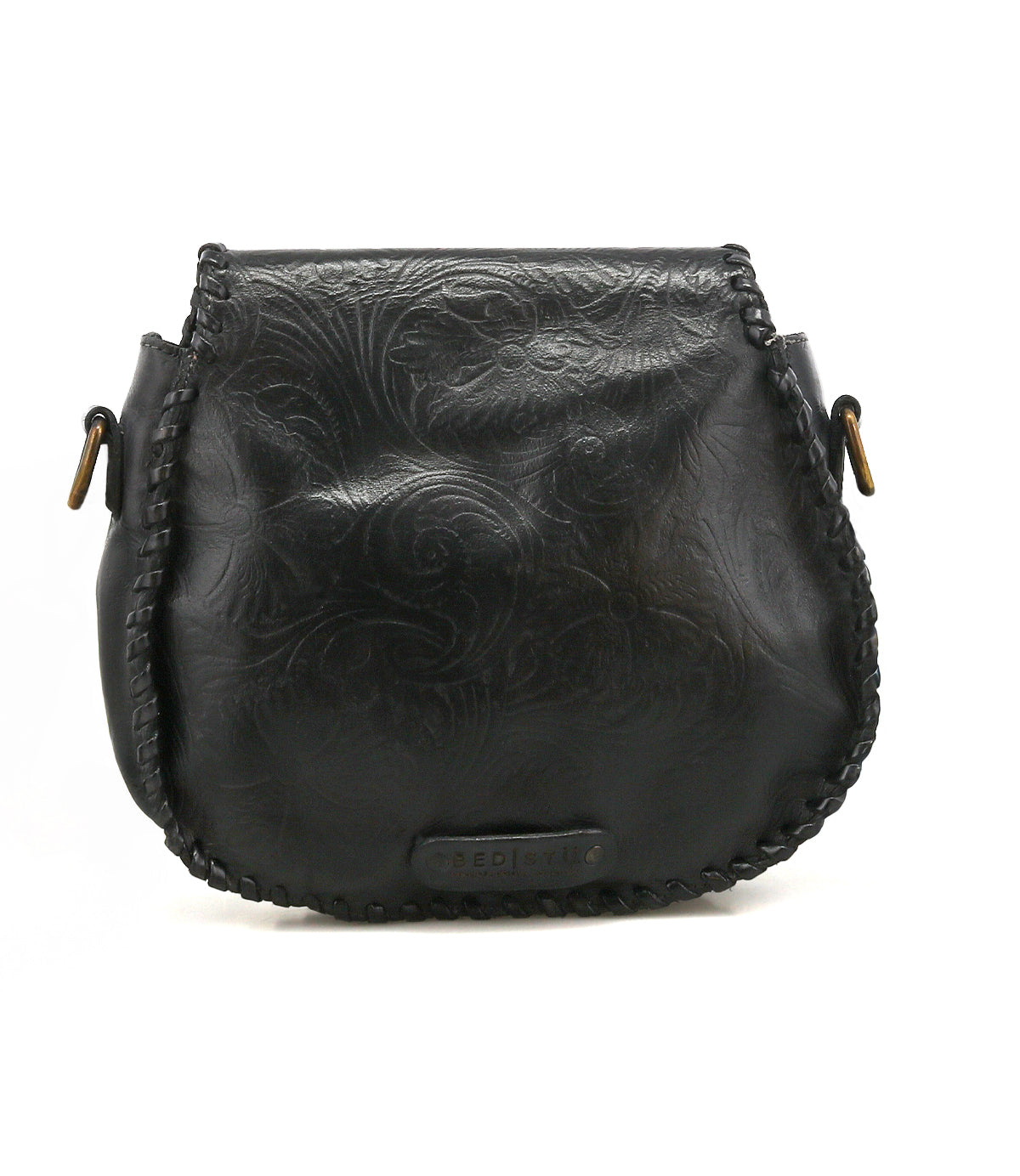 Bed|Stü Half Moon EM black leather saddlebag crossbody featuring an embossed foliage pattern, whipstitch trim along the edges, adjustable strap, and metal hardware at the strap attachments.