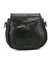 Bed|Stü Half Moon EM black leather saddlebag crossbody featuring an embossed foliage pattern, whipstitch trim along the edges, adjustable strap, and metal hardware at the strap attachments.