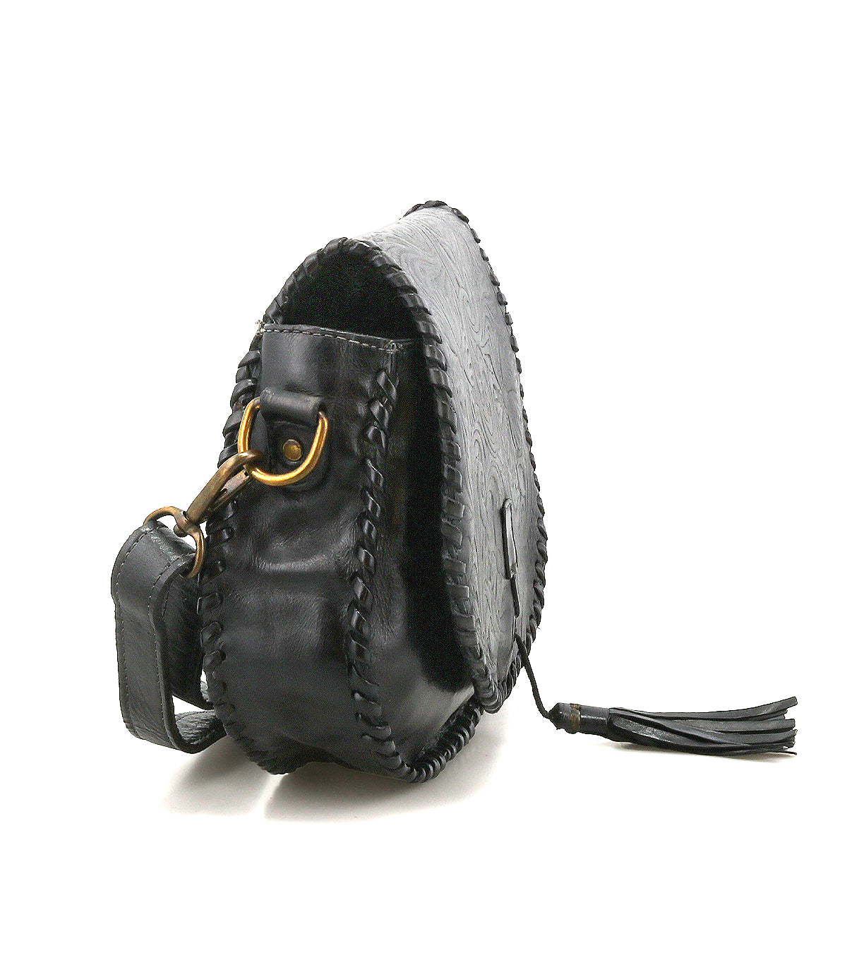 The Bed|Stü Half Moon EM, a black leather saddlebag crossbody purse, features stitched edges, gold-tone hardware, an adjustable strap, and a tassel on the zipper. Presented from a rear side angle against a white background, its elegant silhouette is subtly enhanced by an embossed foliage pattern.