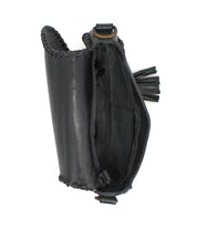The Bed|Stü Half Moon EM is a black leather pouch with visible stitching, featuring an open top, a round metal ring handle, and a tassel detail on the side. This chic saddlebag crossbody purse also comes with an adjustable strap for versatile wear.