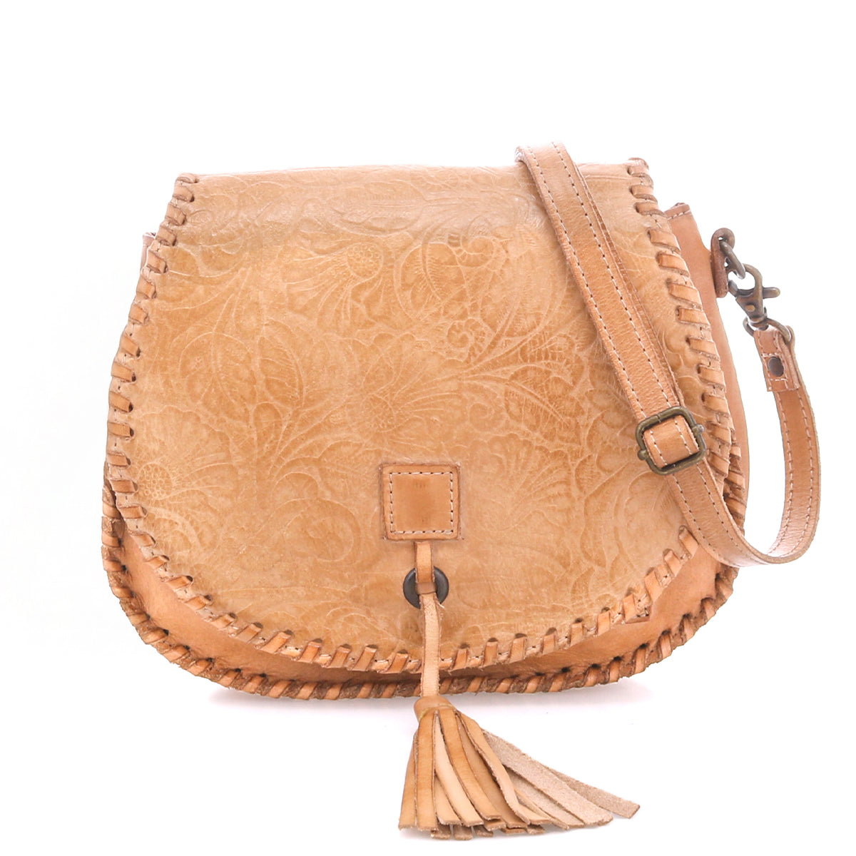 Bed|Stü Half Moon EM tan leather saddlebag crossbody featuring an embossed foliage pattern, whipstitch trim, front flap closure, adjustable strap, and tassel detail.