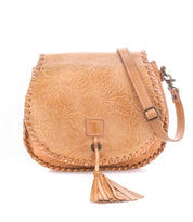 Bed|Stü Half Moon EM tan leather saddlebag crossbody featuring an embossed foliage pattern, whipstitch trim, front flap closure, adjustable strap, and tassel detail.