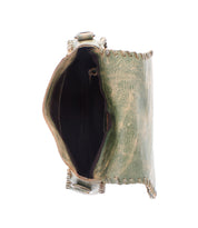 Top view of the Bed|Stü Half Moon bag, a small green leather tassel purse featuring visible hand-laced stitching and an open main compartment, photographed against a white background.