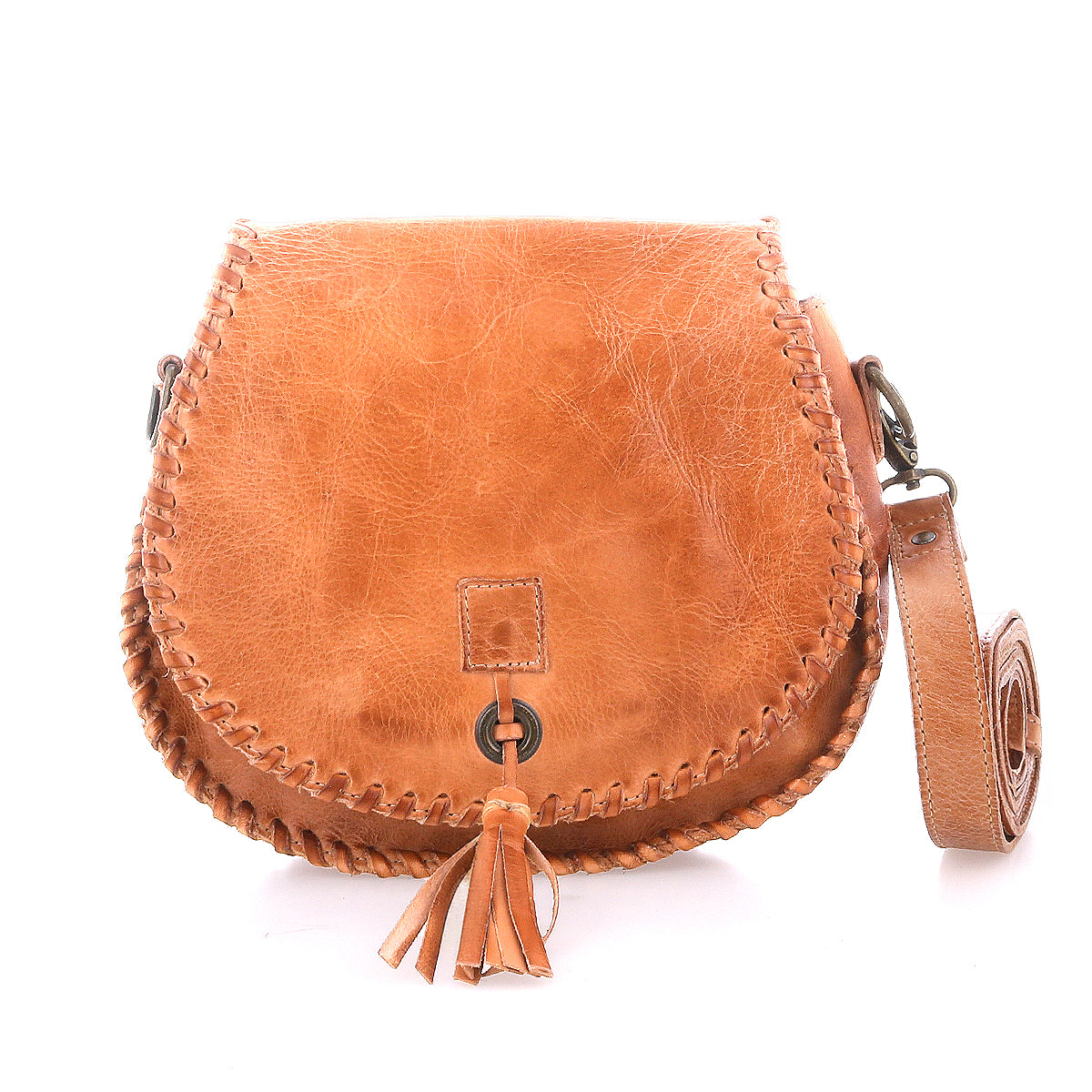 The Bed|Stü Half Moon is a brown leather crossbody bag featuring hand-laced stitching along the edges, a leather tassel accent on the front, and an adjustable strap, displayed on a white background.