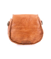The Half Moon by Bed|Stü is a small brown leather crossbody bag featuring visible hand-laced stitching around the edges and a "Bed|Stü" logo patch on the front.