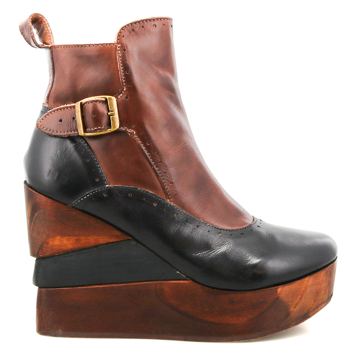 The Harmonious by Bed|Stü is a brown and black leather ankle boot featuring leather uppers, a gold buckle accent, and a chunky, sculpted wood base that forms a striking platform wedge heel.
