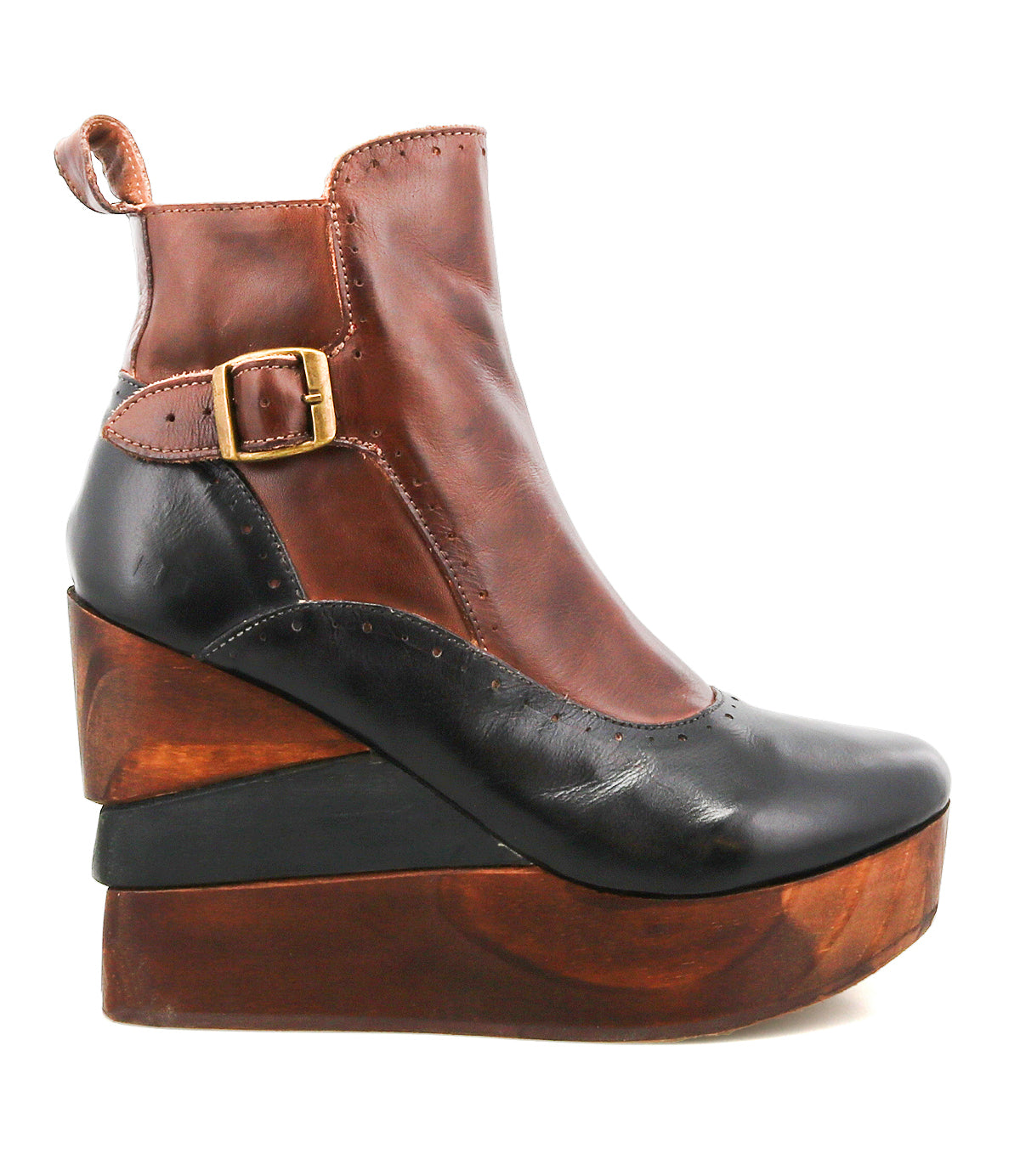 The Harmonious by Bed|Stü is a brown and black leather ankle boot featuring leather uppers, a gold buckle accent, and a chunky, sculpted wood base that forms a striking platform wedge heel.