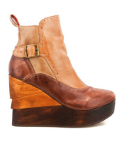 Introducing Harmonious by Bed|Stü, a high platform wedge ankle boot crafted with rich brown leather uppers, distinctive side buckle detail, and a sculpted wood base for a striking, layered look.