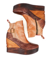 The Harmonious platform wedge ankle boot by Bed|Stü features two-tone leather uppers, a sculpted wood base, side zipper, buckle detail, and pull tab—displayed against a white background.