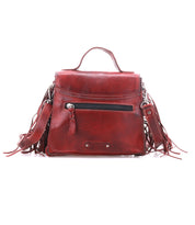 Bed|Stü’s “Hidden” handbag in red features a structured silhouette, top handle, front zipper pocket, and decorative side tassels—crafted from soft leather and showcased against a white background.