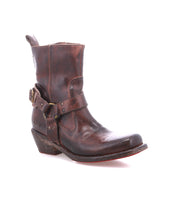 A single Bed|Stü Homage ankle boot in rich brown leather, featuring harness strap and buckle details, is angled slightly to the right against a white background.