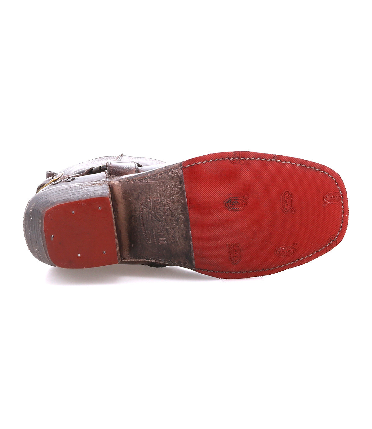 A close-up of the bottom of the Bed|Stü Homage boot showcases its rich brown leather, red rubber sole, and detailed stitching around the edge.