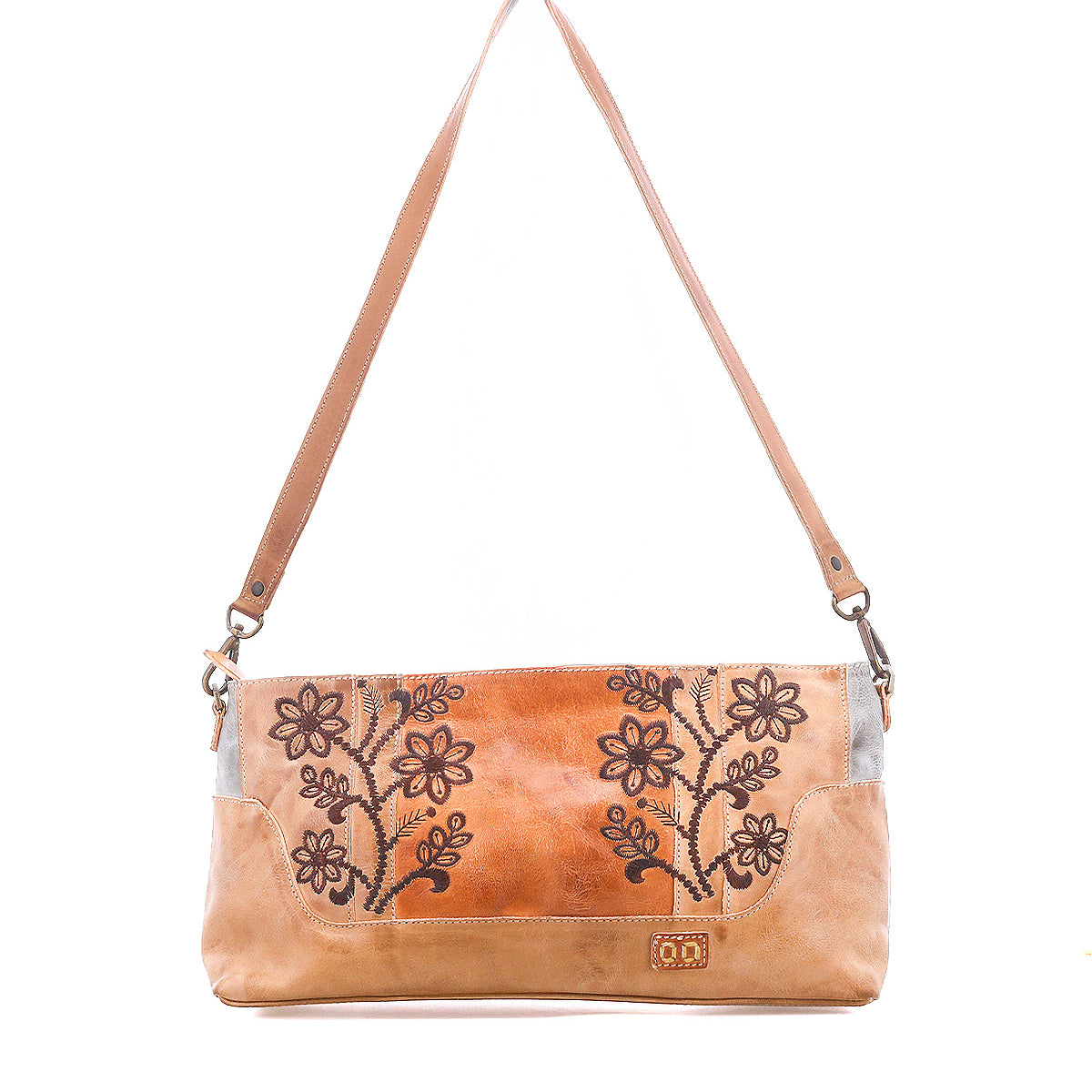 The Bed|Stü Hyperbolic is a tan handcrafted leather shoulder bag featuring floral embroidery, a rectangular silhouette, and a single wide strap, displayed against a white background for a distinctive touch of bohemian charm.