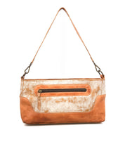 The Bed|Stü Hyperbolic is a handcrafted tan and cream leather shoulder bag, featuring a front zipper pocket and a detachable strap, displayed against a plain white background.