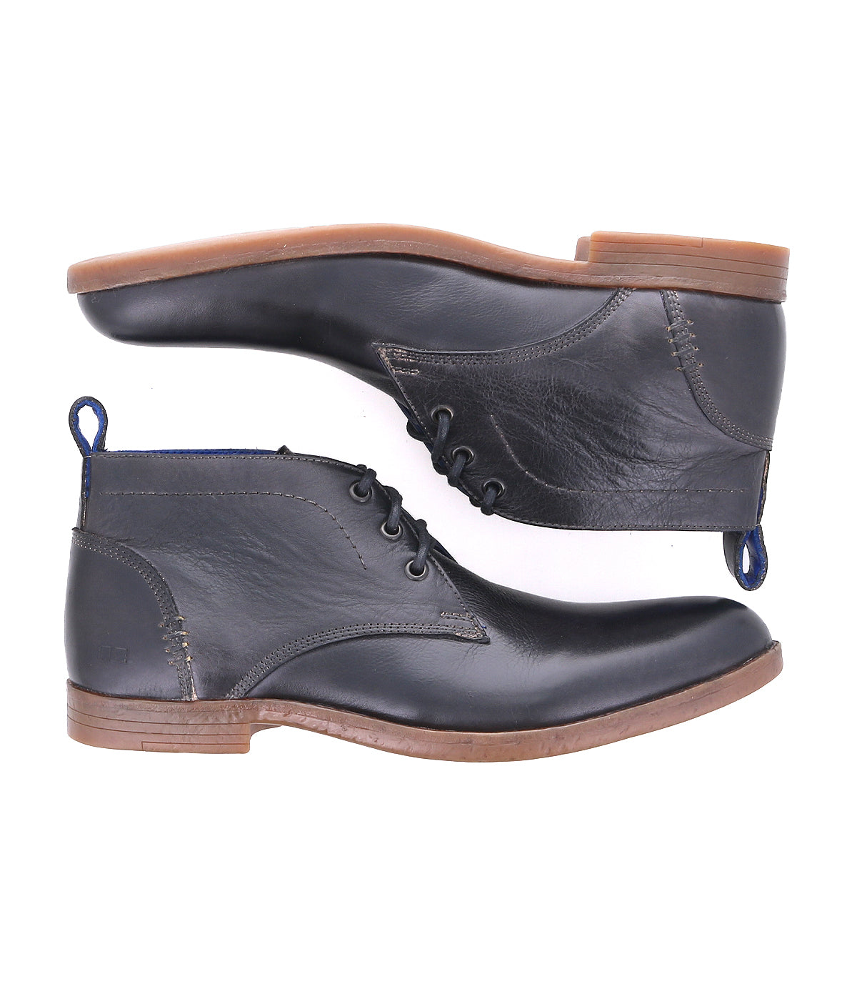 Two Illiad black leather chukka ankle boots by Bed|Stü, featuring brown soles, are shown from a side view, stacked one above the other against a white background. These modern lace-up boots offer comfortable outsoles and blend timeless style with everyday comfort.