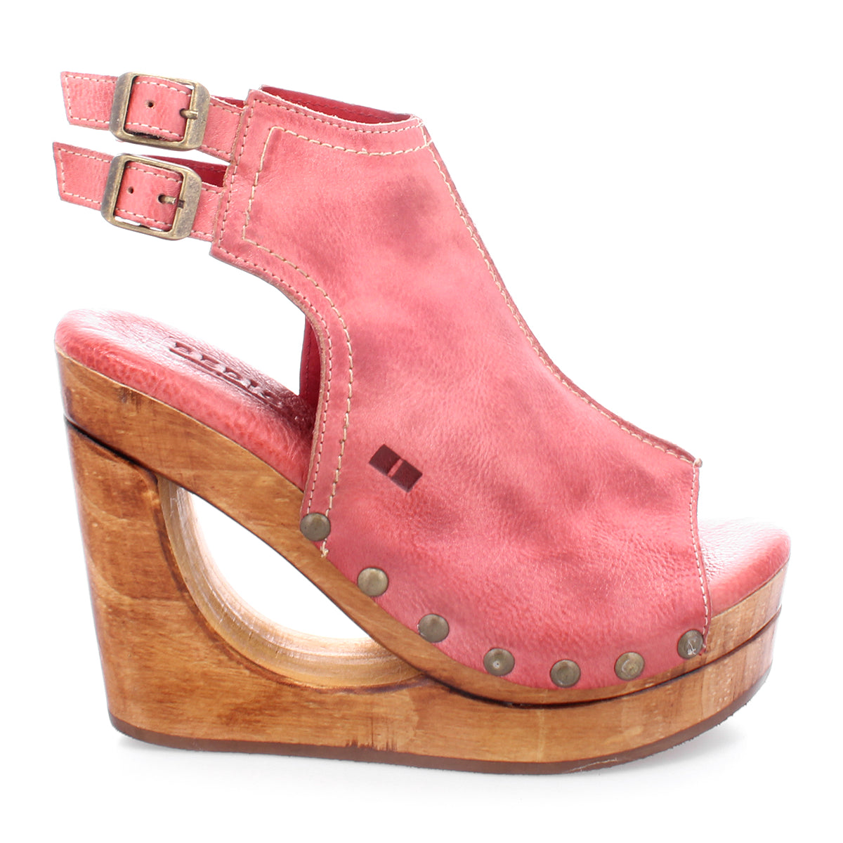 Introducing Imelda by Bed|Stü: a pink cutout wedge peep-toe sandal featuring a wooden platform, dual adjustable ankle buckles, and metallic studs accenting the open-toe silhouette.