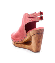 Imelda by Bed|Stü is a red leather open-back clog sandal featuring an open-toe silhouette, wooden wedge heel, brass rivet accents, double adjustable ankle buckles, and decorative stitching, shown on a white background.