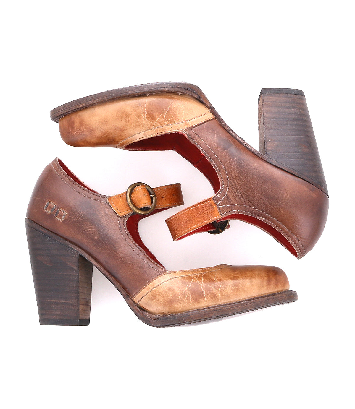 A pair of Bed|Stü Ishtar brown leather Mary Jane pumps featuring adjustable straps and chunky block heels, shown on a white background with one shoe stacked atop the other.
