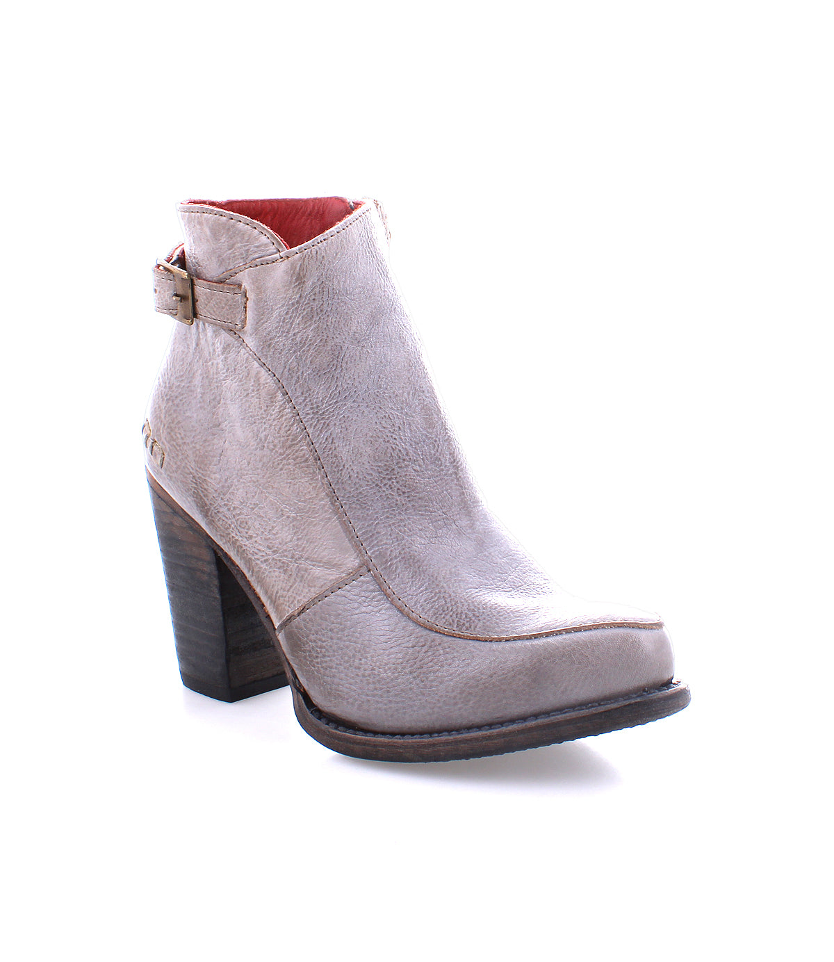 The Isla bootie by Bed|Stü is crafted from smooth taupe leather and features a medium-high wooden block heel, visible stitching, and a side buckle detail. The boot is angled to display its outer side and front.