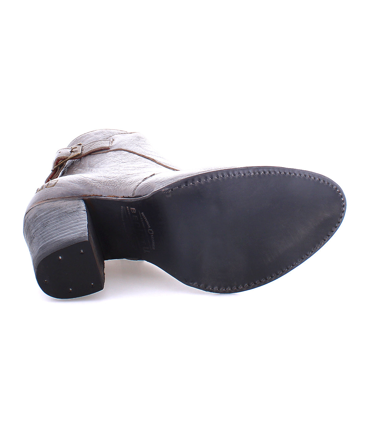 The Bed|Stü Isla heeled bootie in gray is shown from the bottom, highlighting the sole, heel, and a portion of its smooth leather upper against a white background.