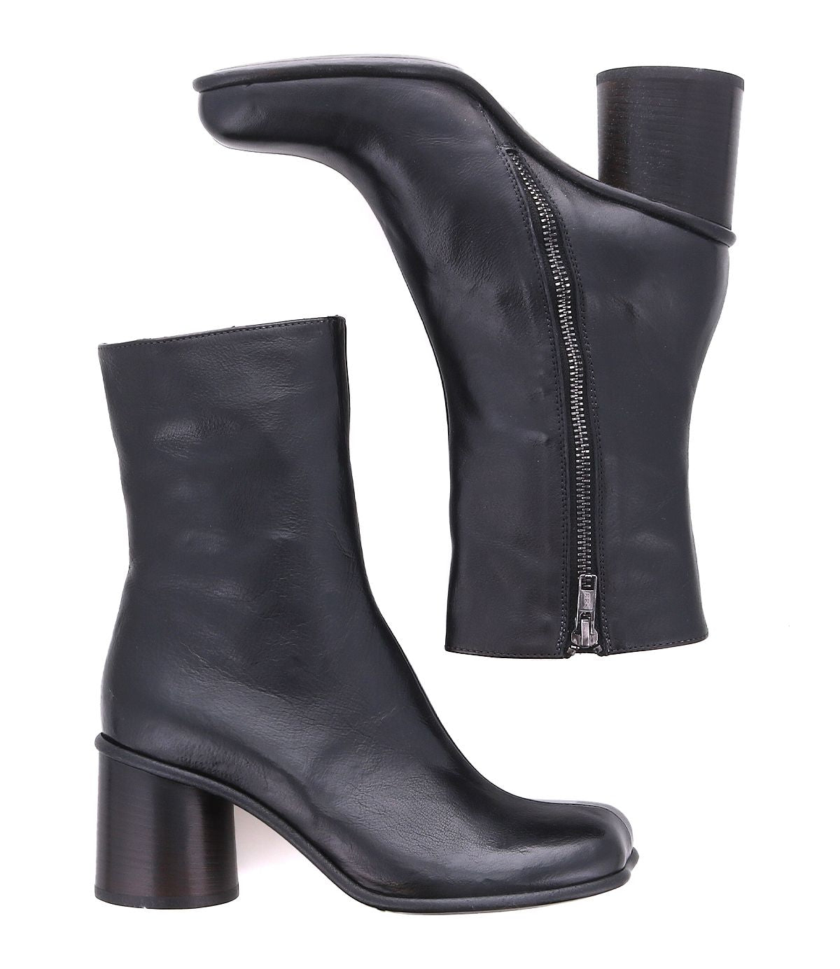 Two black Isodora ankle boots by Bed|Stü, handcrafted in Italian leather with rounded toes, medium-height cylindrical heels, and side zippers. Shown from a side view and a bottom view against a white background, these boots feature durable Blake-stitched construction for refined style.