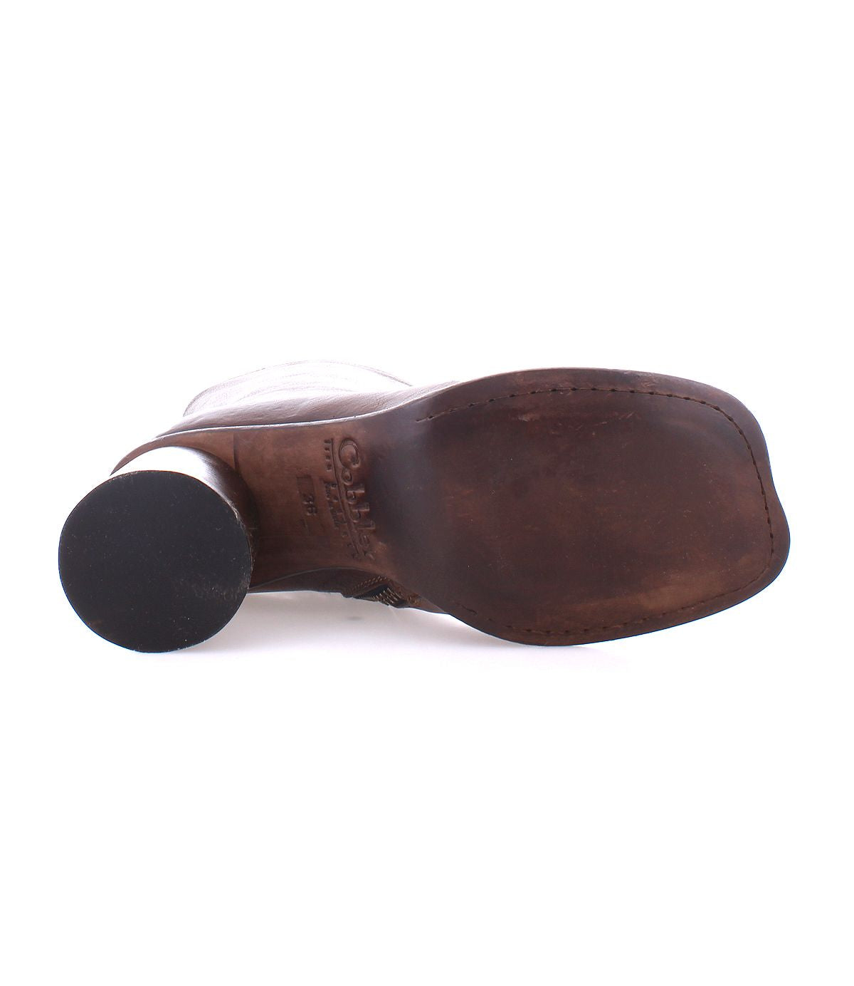 The image shows the sole of the Isodora by Bed|Stü, a brown leather shoe featuring a dark, round heel and visible stitching around the edges—hallmarks of Blake-stitched construction often found in premium Italian leather boots.
