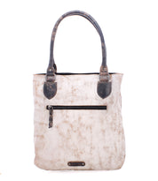 The Bed|Stü Italic is a beige leather tote bag with dark handles and a front zipper pocket, featuring padded shoulder straps for added comfort, photographed against a white background.