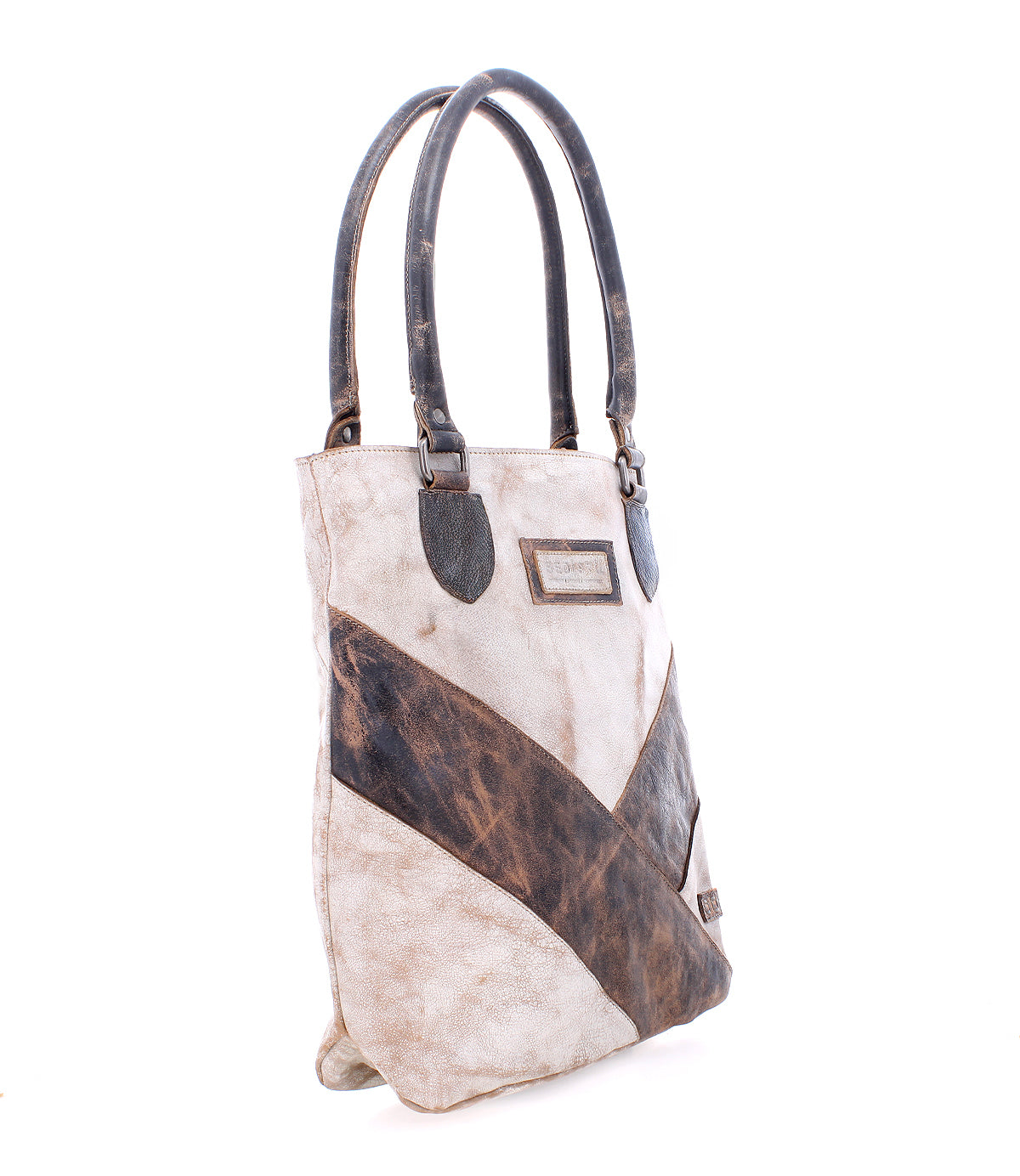 Introducing the Italic by Bed|Stü—a two-handle leather tote bag crafted in a patchwork of distressed beige and brown leather. It features padded shoulder straps, a rectangular branded label on the front, and an interior lined with organic cotton for enhanced comfort and eco-friendly appeal.