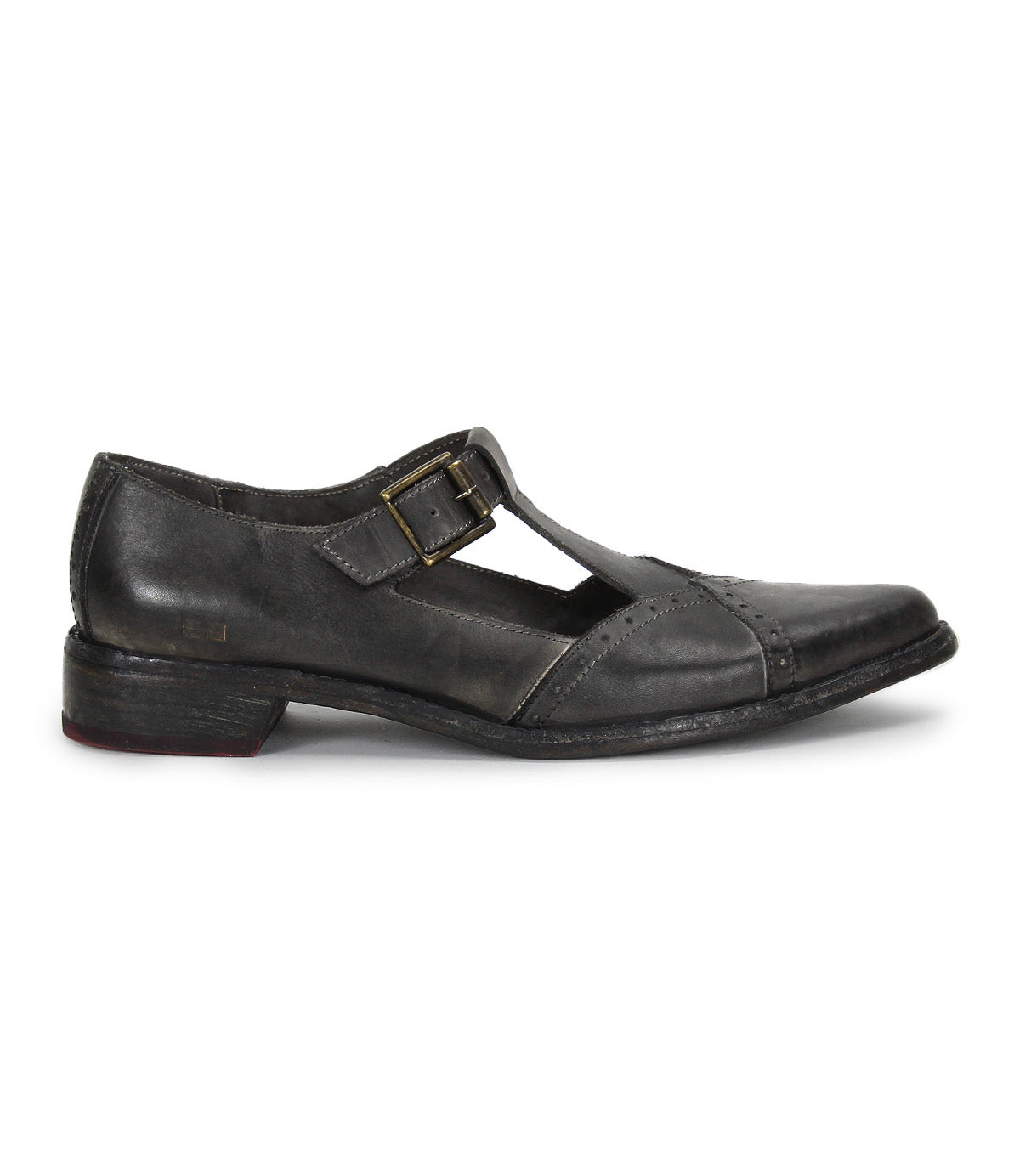 The Bed|Stü Jenny is a single black leather T-bar shoe with a buckle strap and low heel, featuring a cushioned insole for added comfort, shown in profile on a white background.
