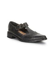 The Bed|Stü Jenny is a black leather Mary Jane T-strap shoe featuring a low heel, cushioned insole, buckle closure, and round toe, shown on a white background.